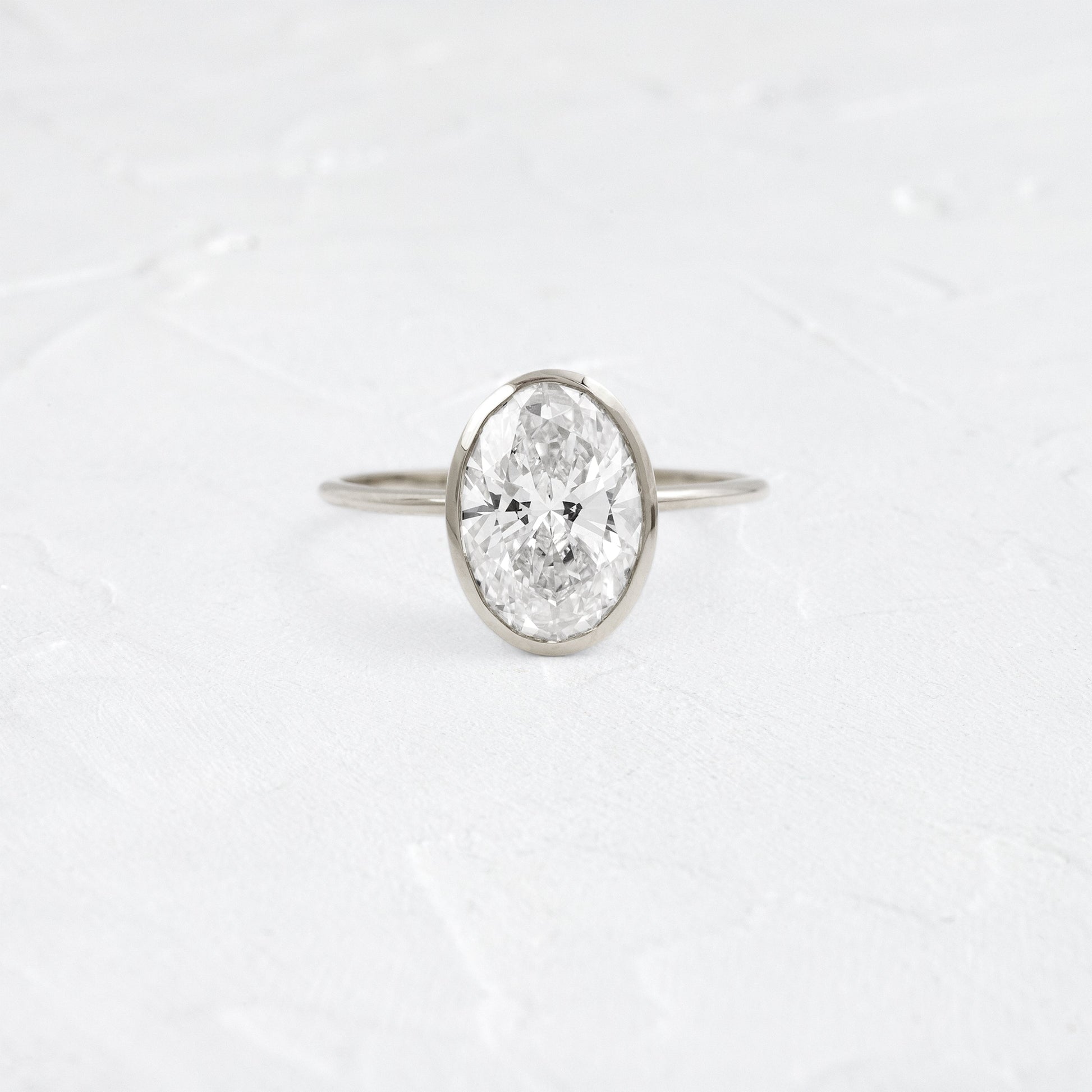 Bezel with Hidden Stones-Oval Lab Grown Diamond Engagement Ring - On model