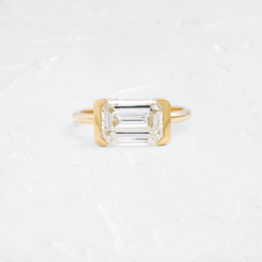 East West Solitaire Half Bezel-Emerald Lab Grown Diamond Engagement Ring - Front view