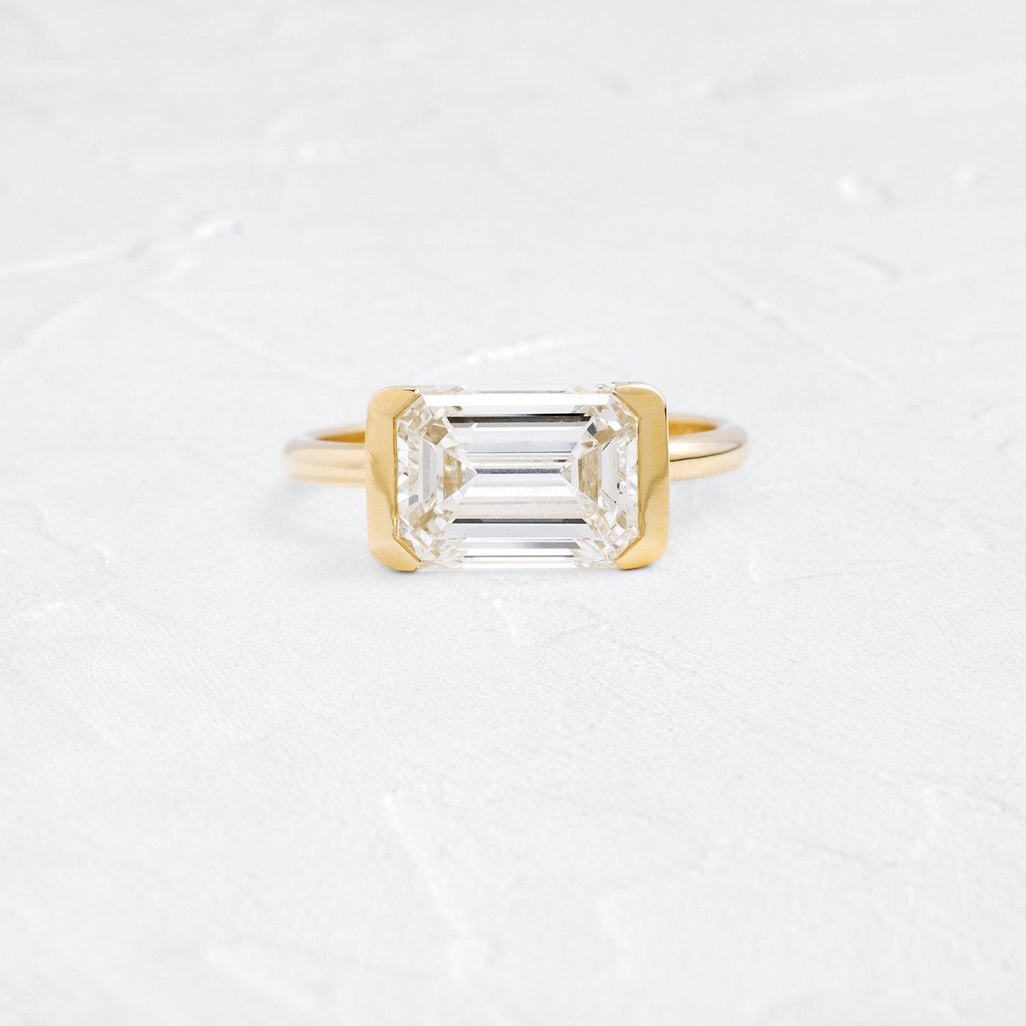 East West Solitaire Half Bezel-Emerald Lab Grown Diamond Engagement Ring - Front view