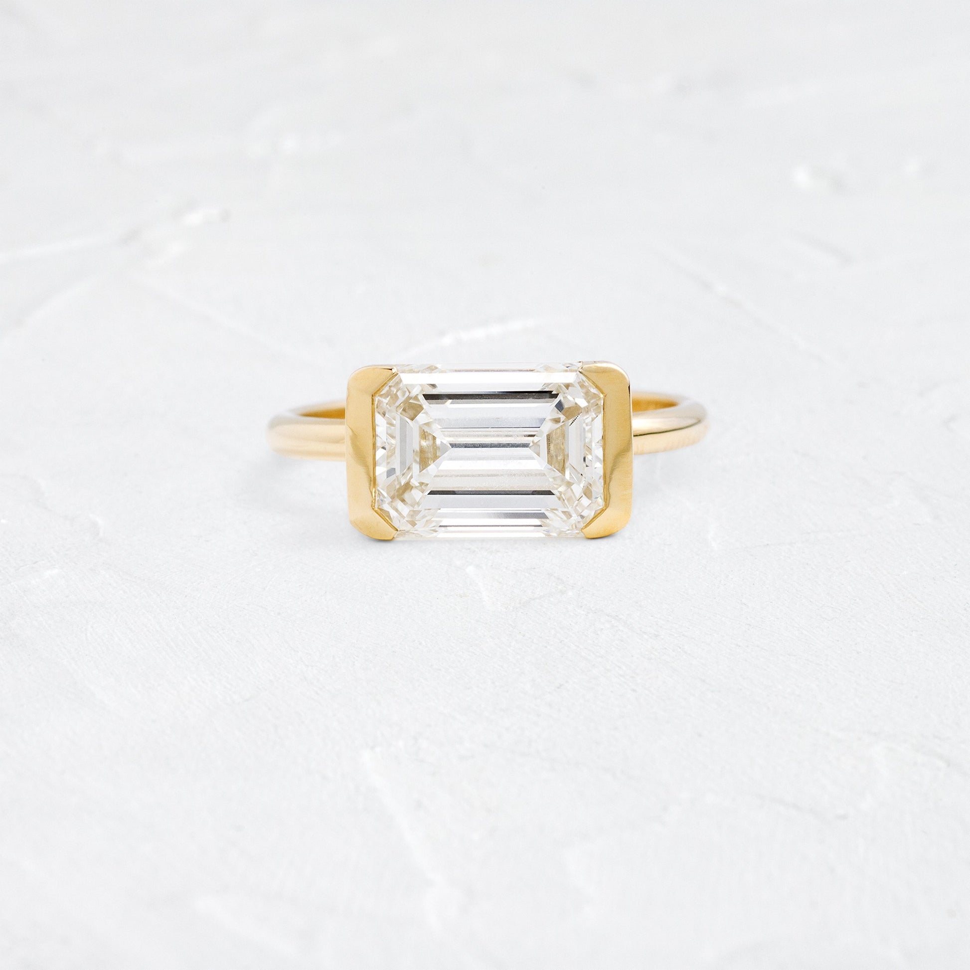 East West Solitaire Half Bezel-Emerald Lab Grown Diamond Engagement Ring - Front view