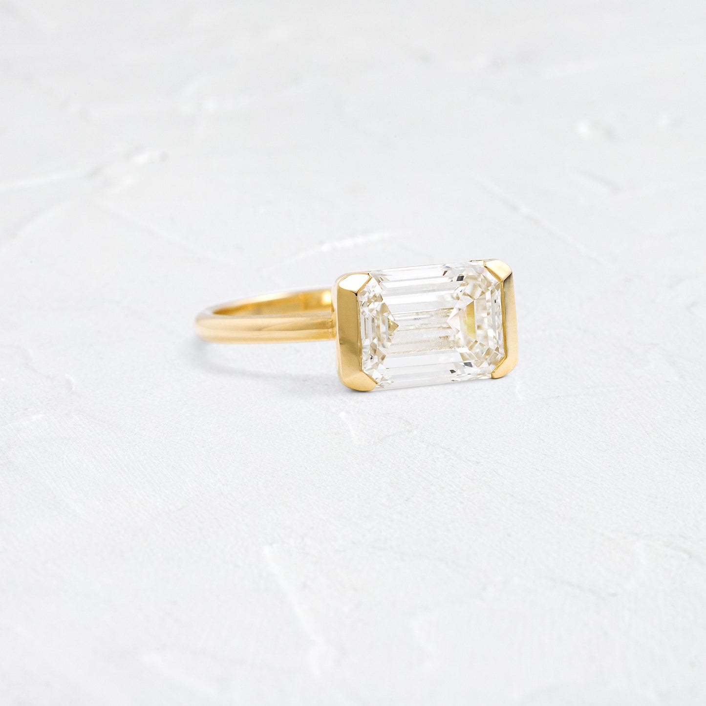 East West Solitaire Half Bezel-Emerald Lab Grown Diamond Engagement Ring - Front view