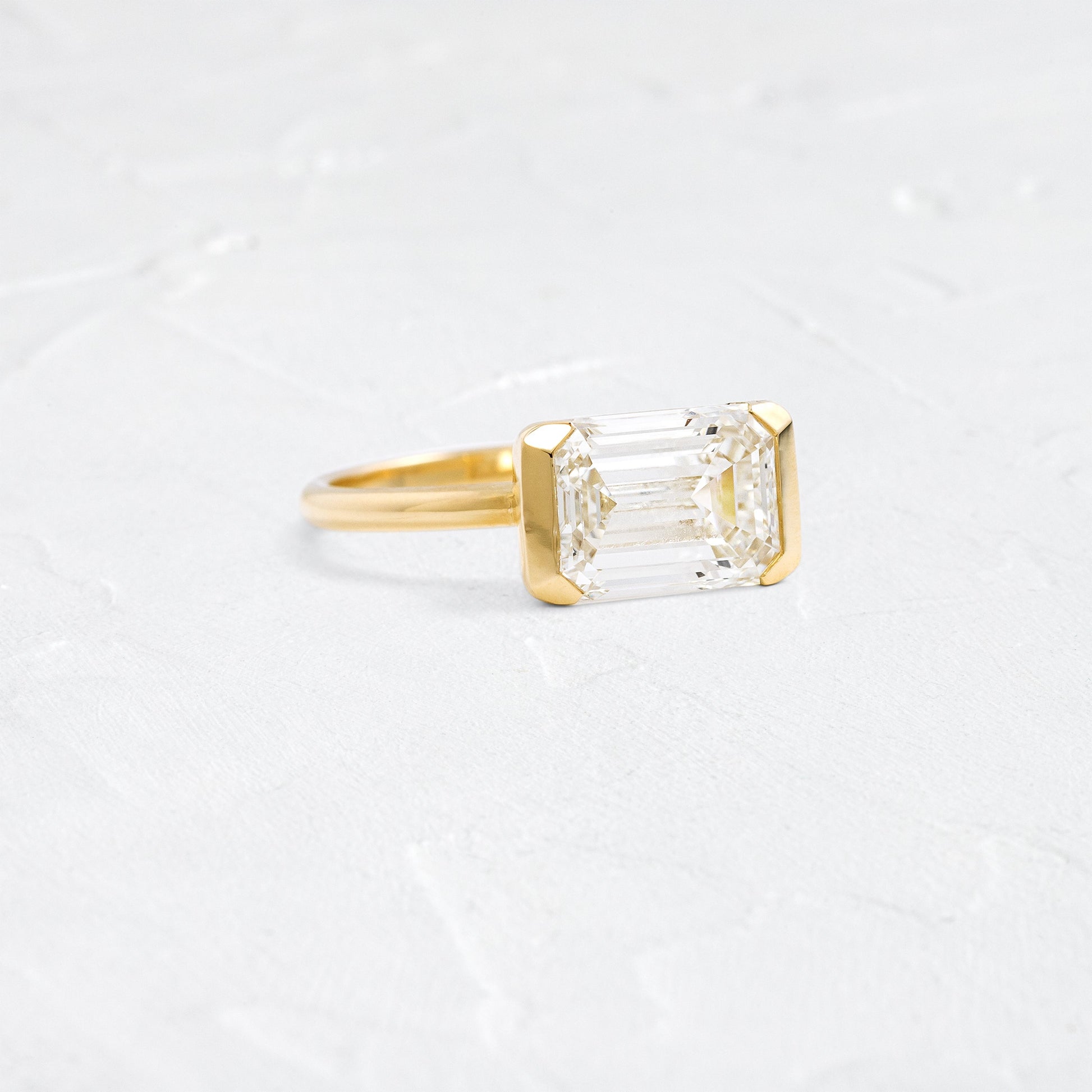 East West Solitaire Half Bezel-Emerald Lab Grown Diamond Engagement Ring - Front view