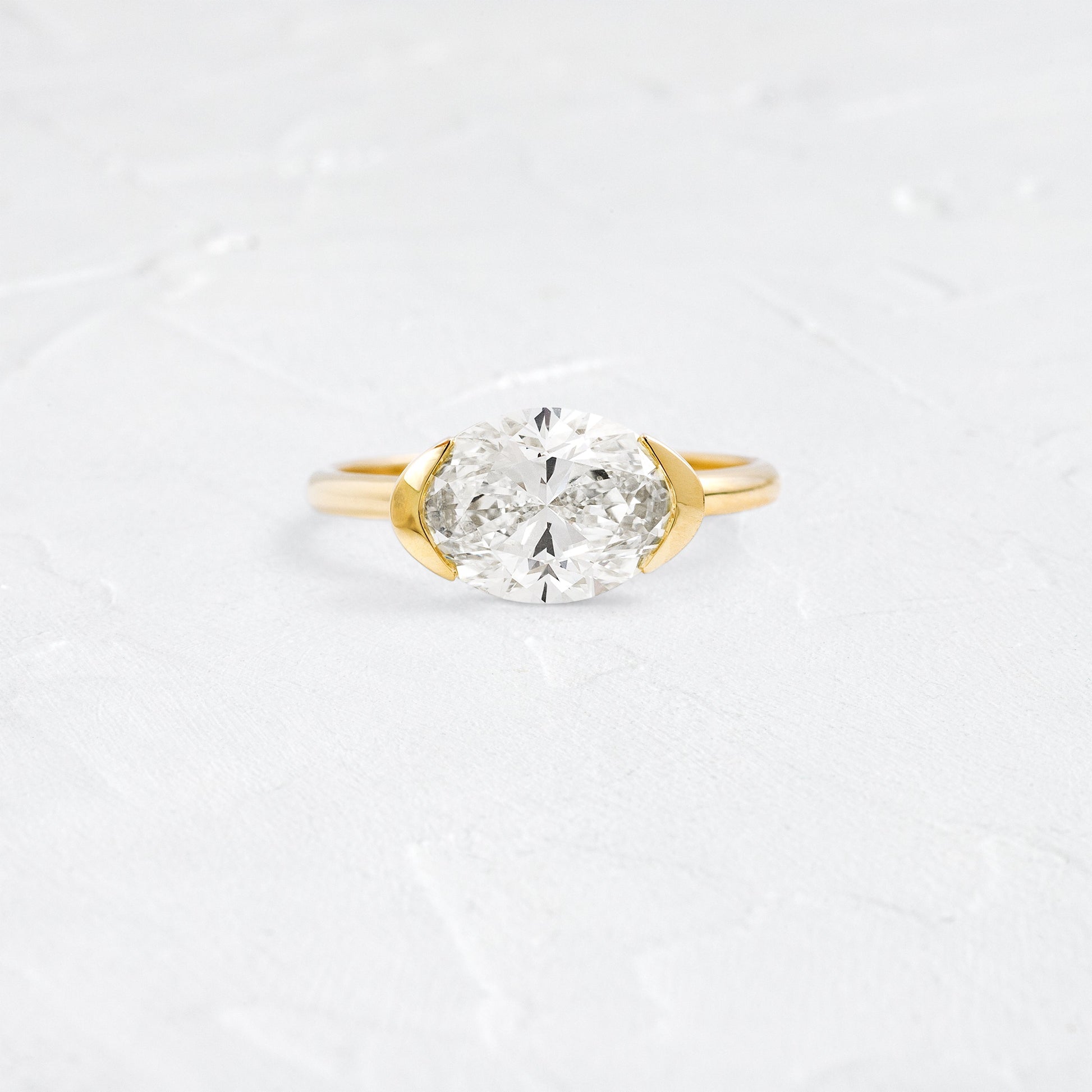 East West Solitaire Half Bezel-Oval Lab Grown Diamond Engagement Ring - Front view