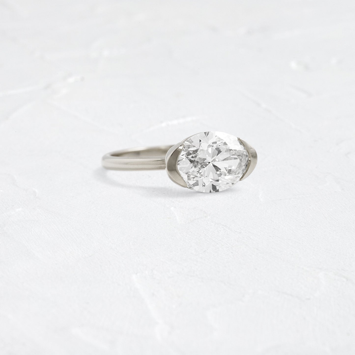 East West Solitaire Half Bezel-Oval Lab Grown Diamond Engagement Ring - Detail view
