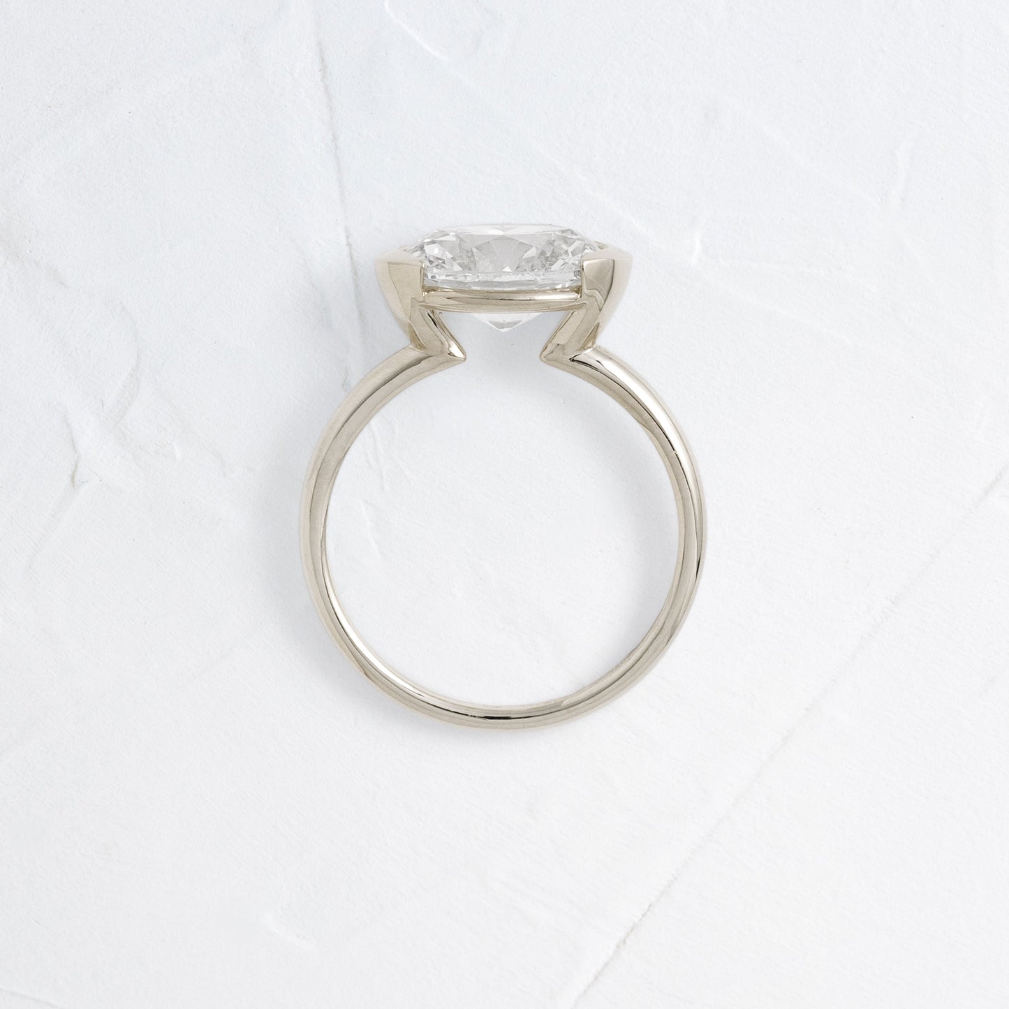 East West Solitaire Half Bezel-Oval Lab Grown Diamond Engagement Ring - On model