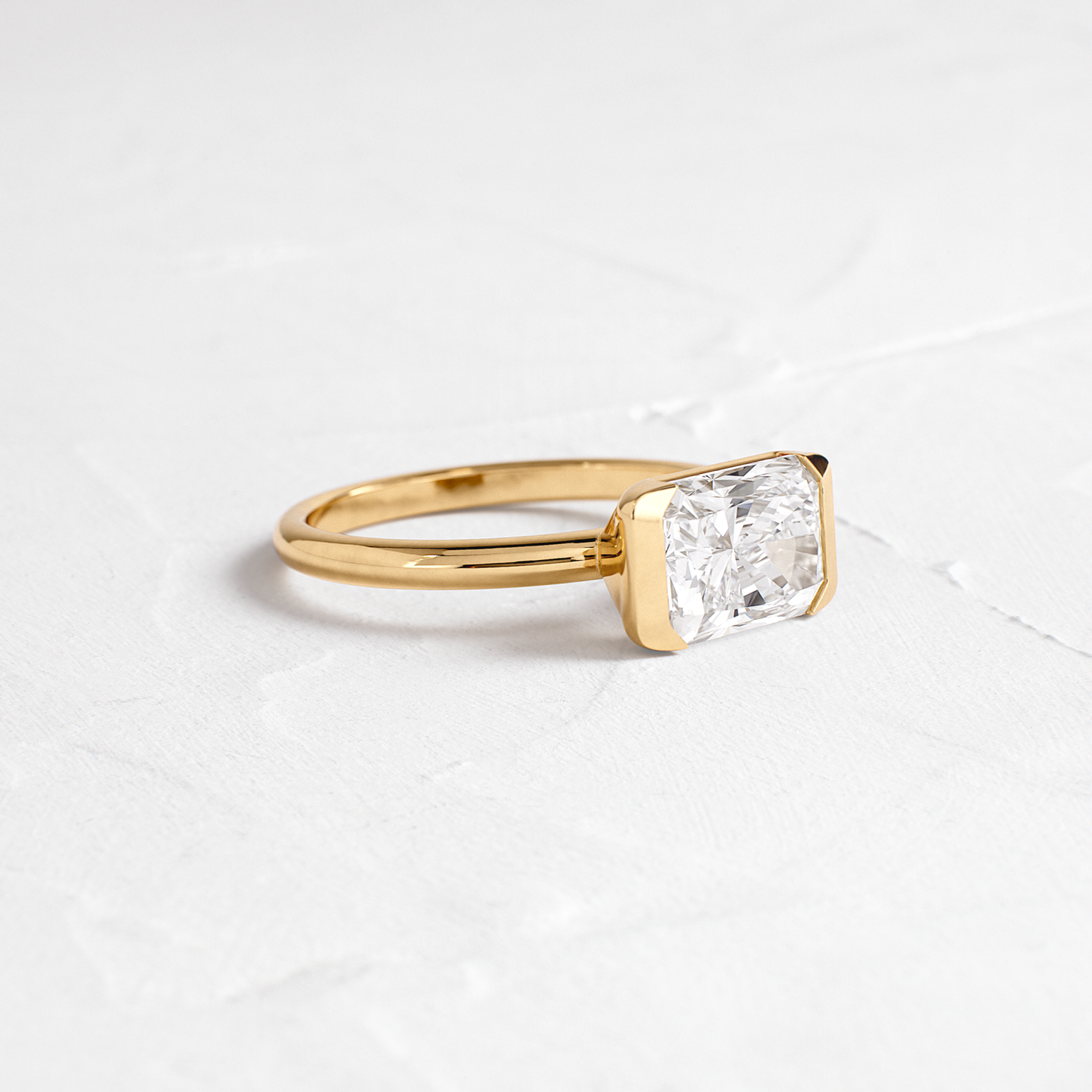 East West Solitaire Half Bezel-Radiant Lab Grown Diamond Engagement Ring - Front view
