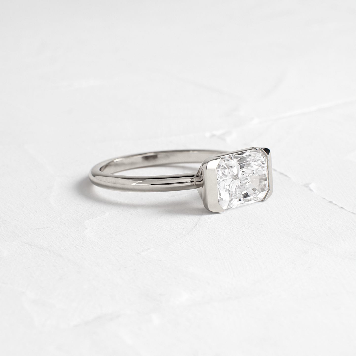 East West Solitaire Half Bezel-Radiant Lab Grown Diamond Engagement Ring - On model