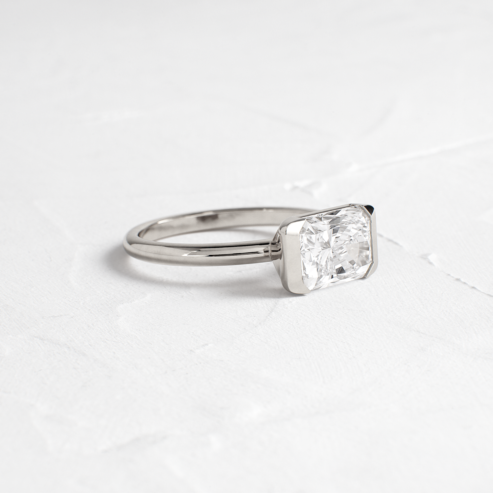 East West Solitaire Half Bezel-Radiant Lab Grown Diamond Engagement Ring - On model