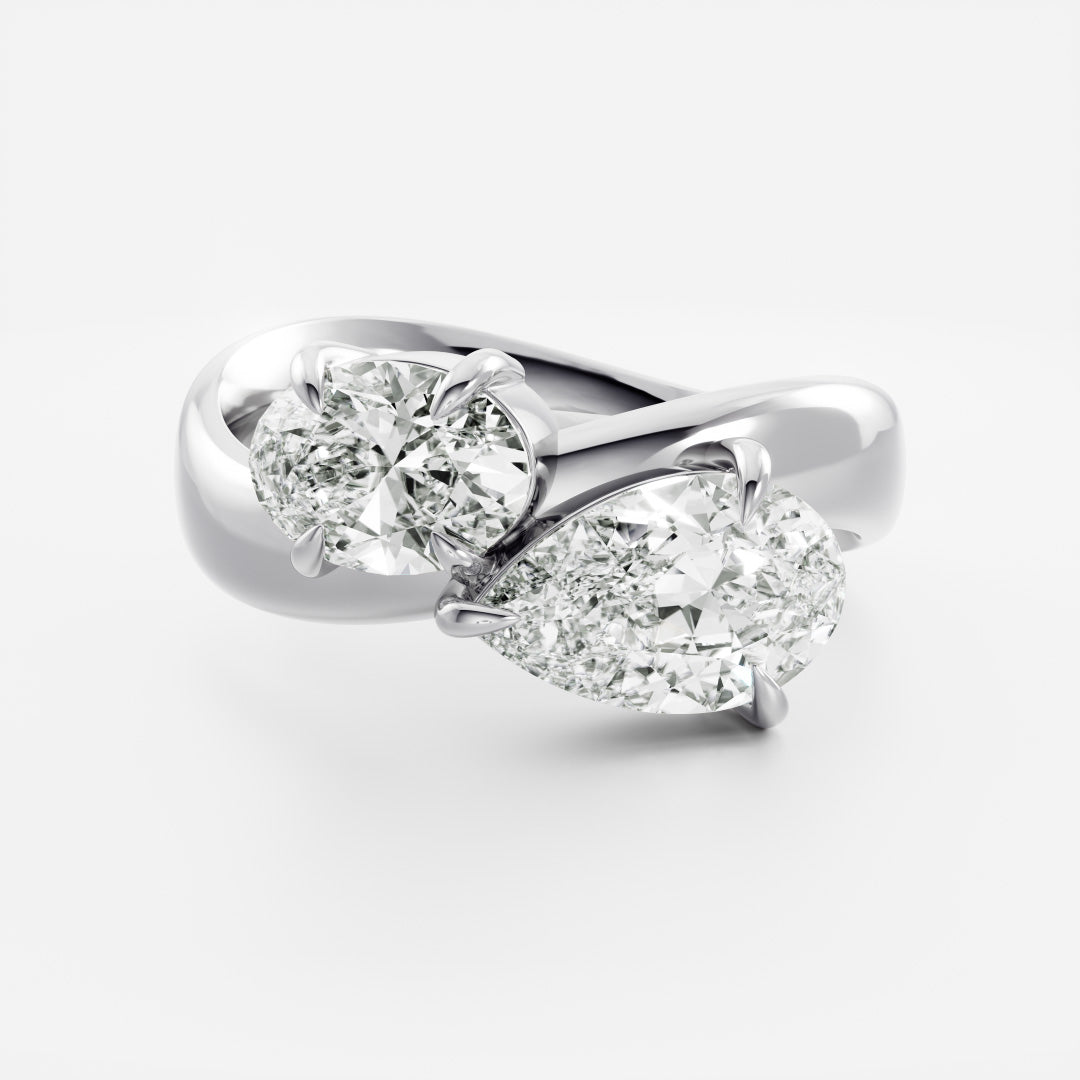 East West Toi Et Moi Curved Band- 1.33 CT Pear & 1.3 CT Oval Moissanite Engagement RingEast West Toi Et Moi Curved Band- 1.33 CT Pear & 1.3 CT Oval Moissanite Engagement Ring - On model