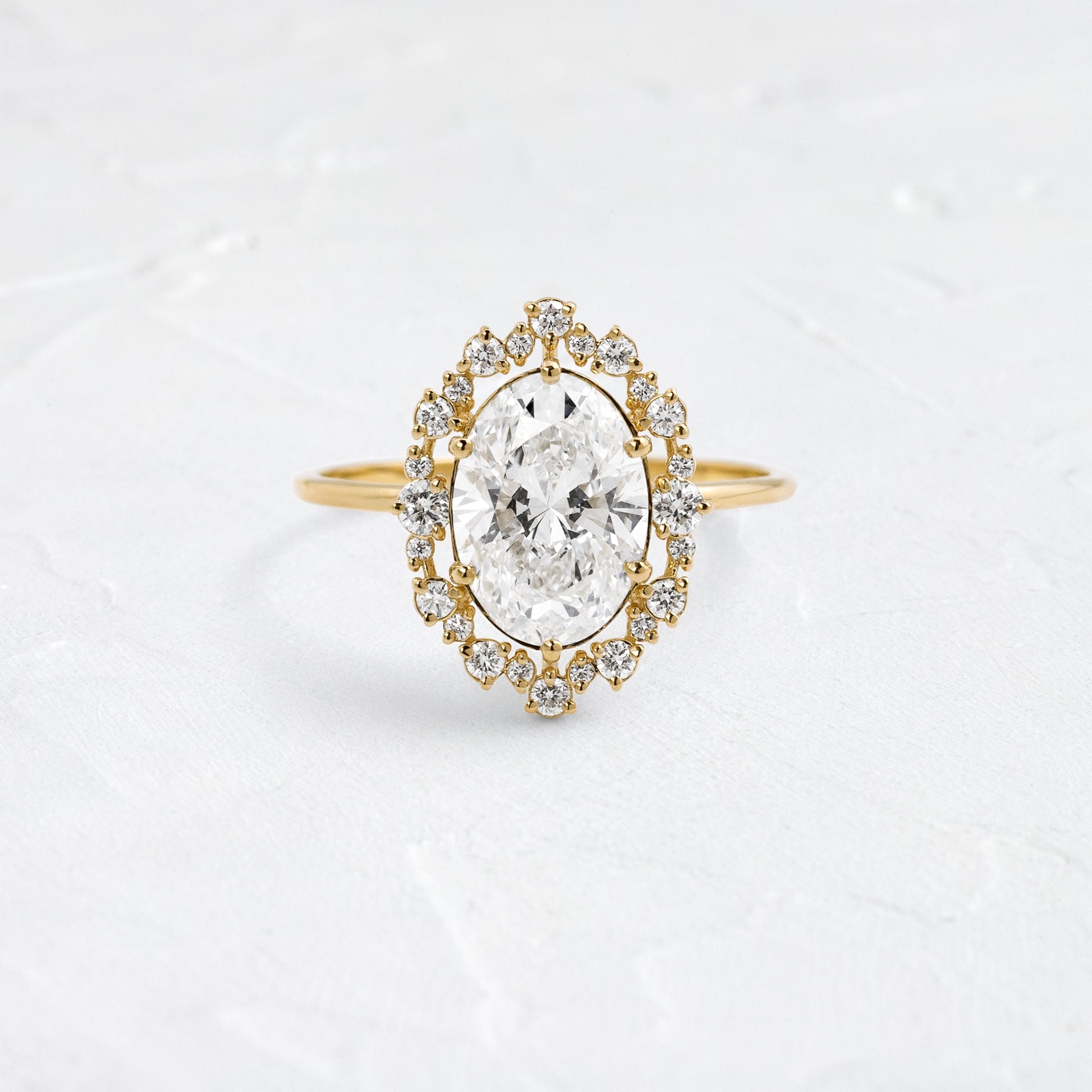 Graduated Halo-Oval Lab Grown Diamond Engagement Ring - Front view