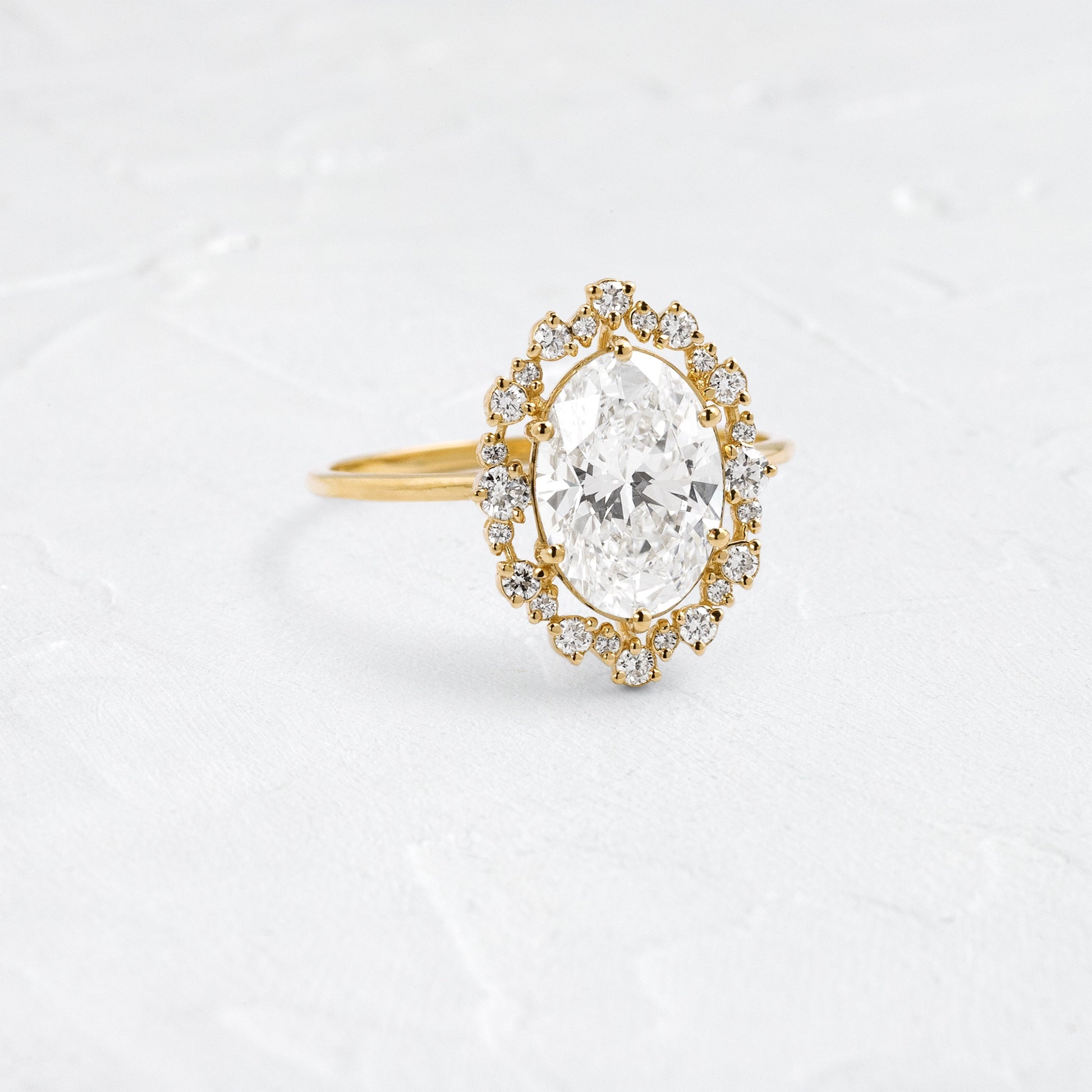 Graduated Halo-Oval Lab Grown Diamond Engagement Ring - Front view