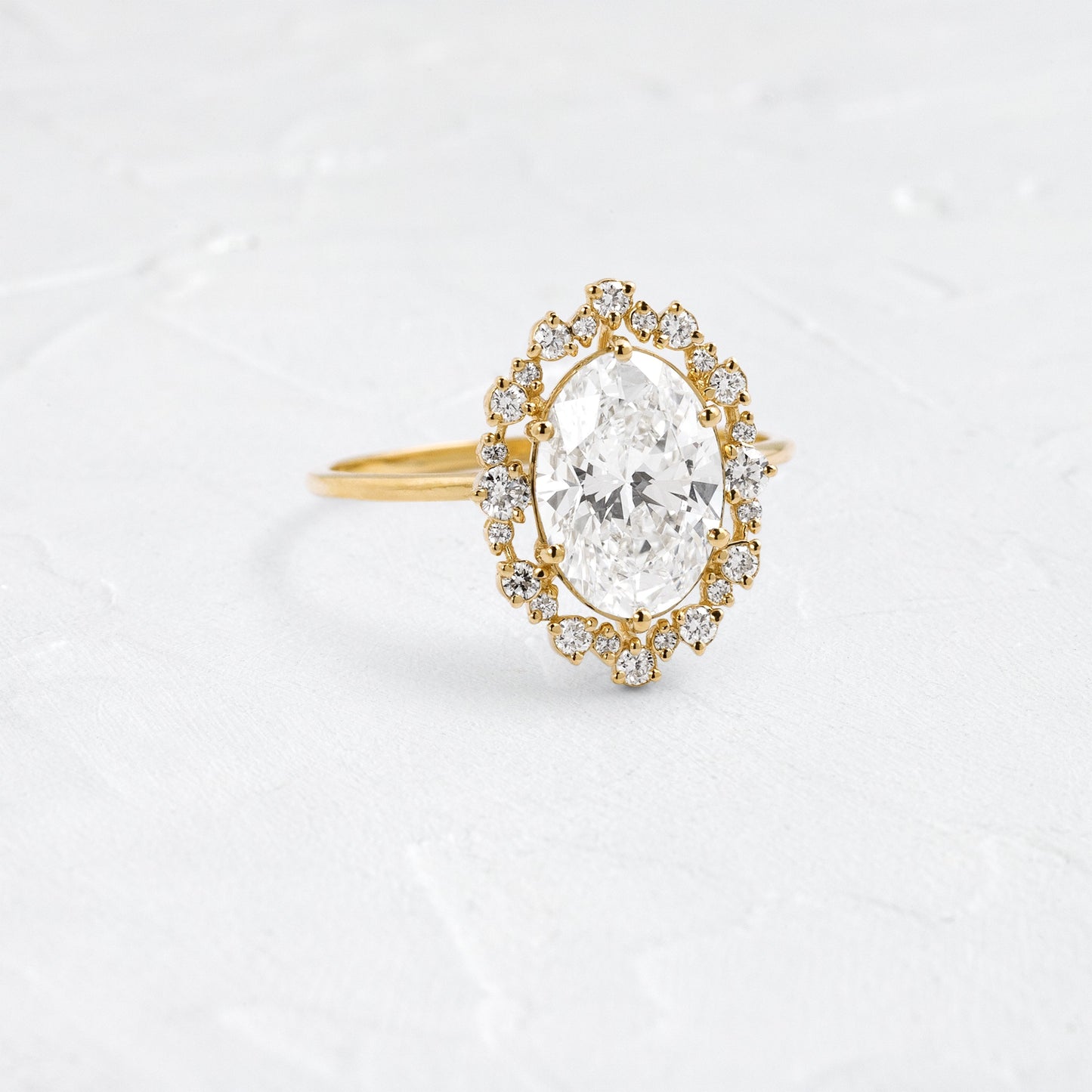 Graduated Halo-Oval Lab Grown Diamond Engagement Ring - Front view
