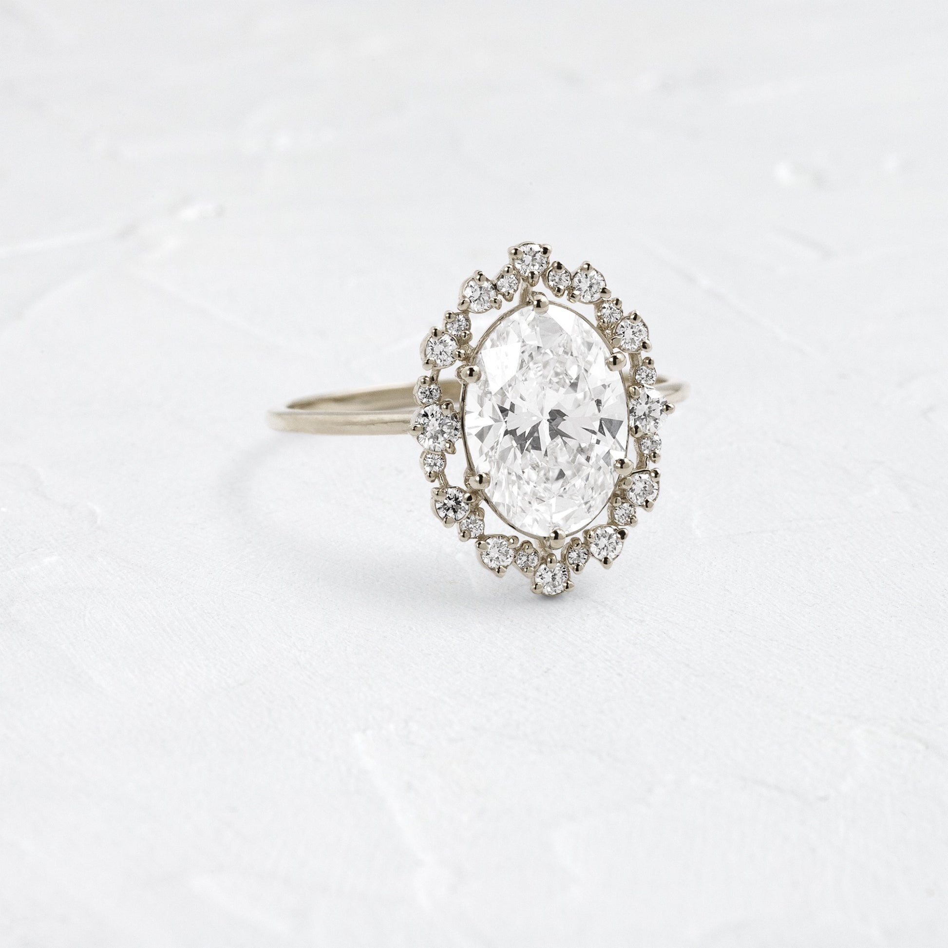 Graduated Halo-Oval Lab Grown Diamond Engagement Ring - On model