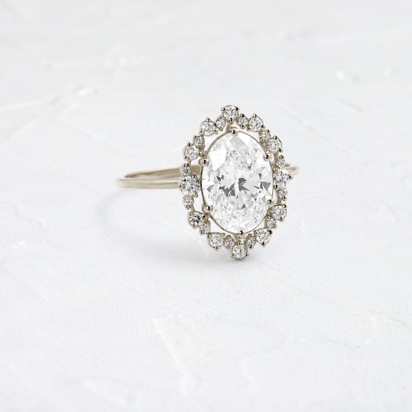 Graduated Halo-Oval Lab Grown Diamond Engagement Ring - On model