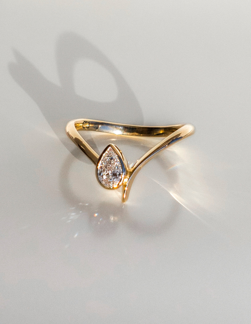 Solitaire Bezel Asymmetrical Band-Pear Lab Grown Diamond Engagement Ring - Front view