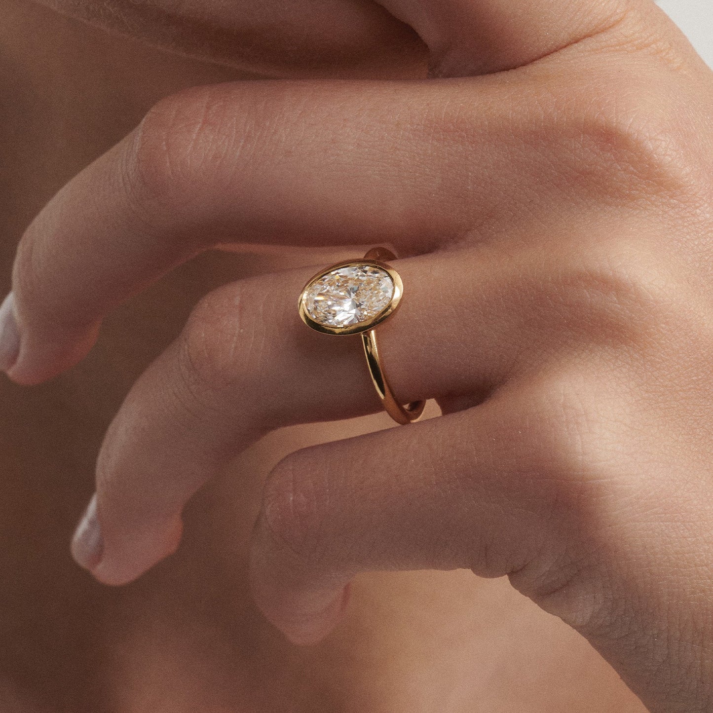 Solitaire Bezel-Oval Lab Grown Diamond Engagement Ring - On model