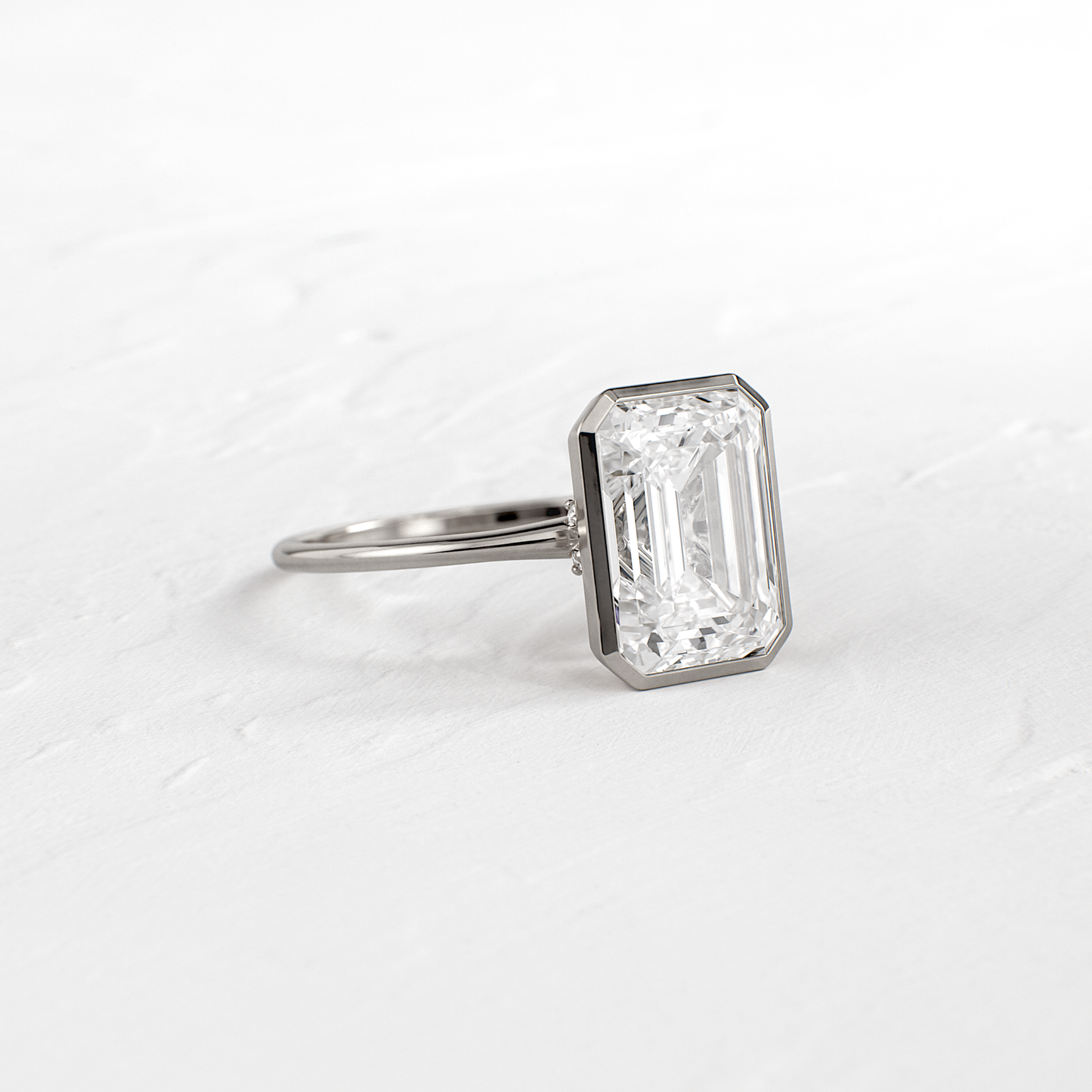 Solitaire Bezel with Hidden Stone-Emerald Lab Grown Diamond Engagement Ring - On model