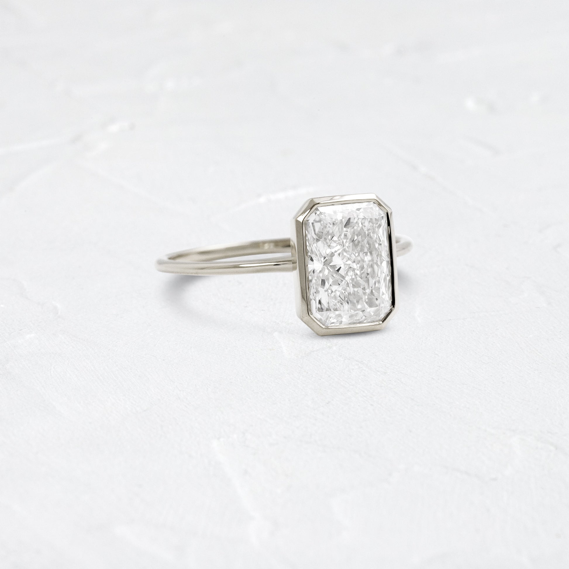 Solitaire Bezel with Hidden Stone-Radiant Lab Grown Diamond Engagement Ring - Detail view