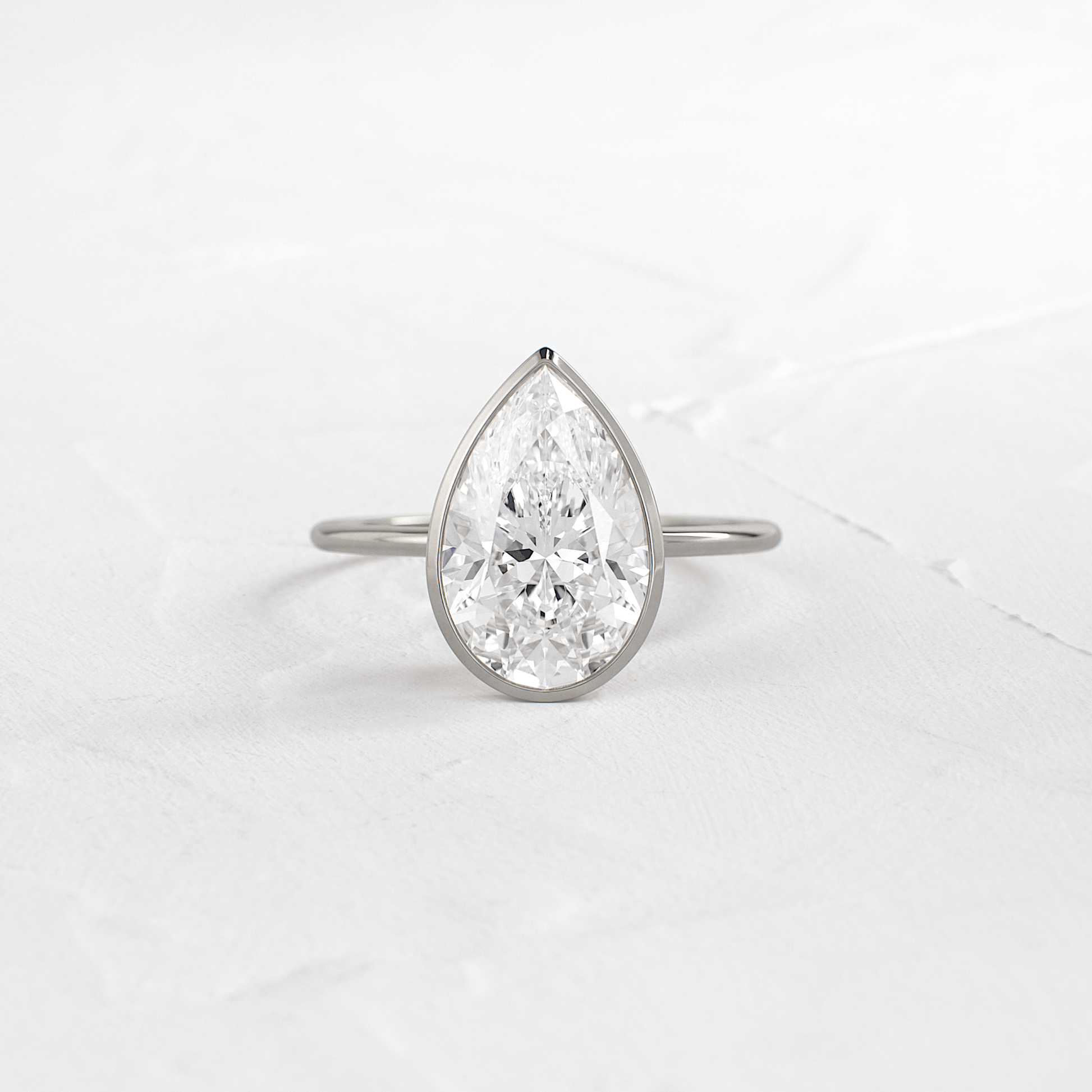 Solitaire Bezel with Hidden Stones-Pear Lab Grown Diamond Engagement Ring - Detail view