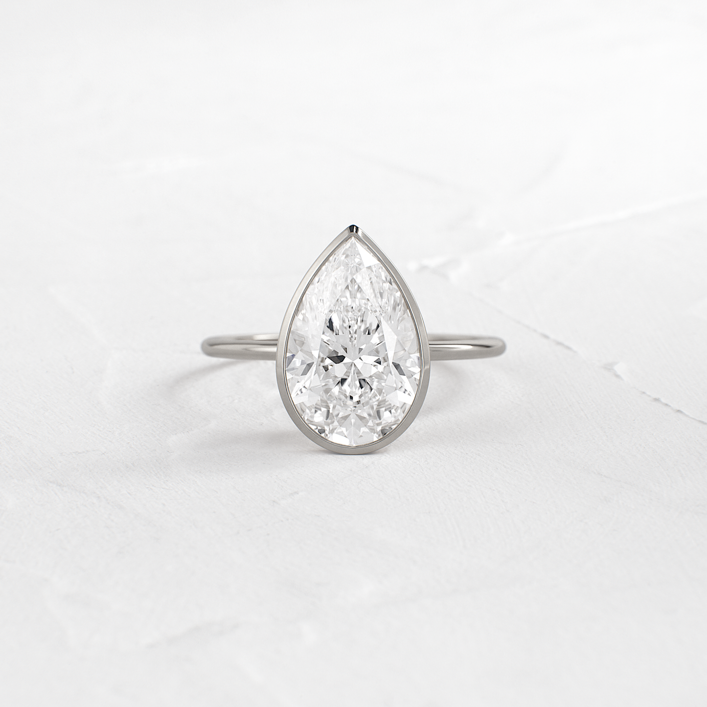 Solitaire Bezel with Hidden Stones-Pear Lab Grown Diamond Engagement Ring - Detail view