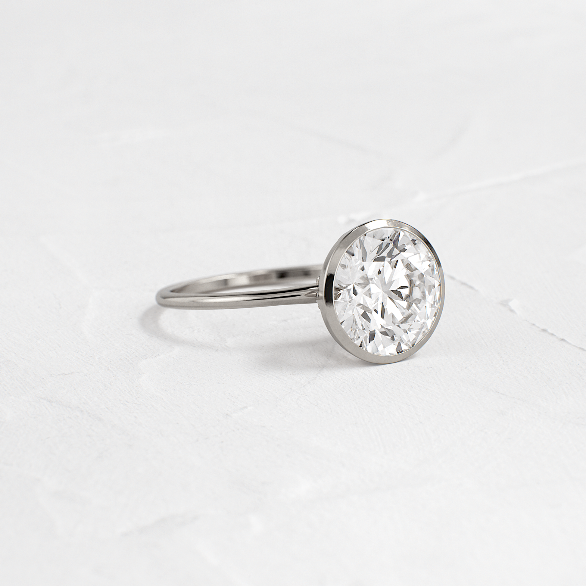 Solitaire Bezel with Hidden Stones-Round Lab Grown Diamond Engagement Ring - On model