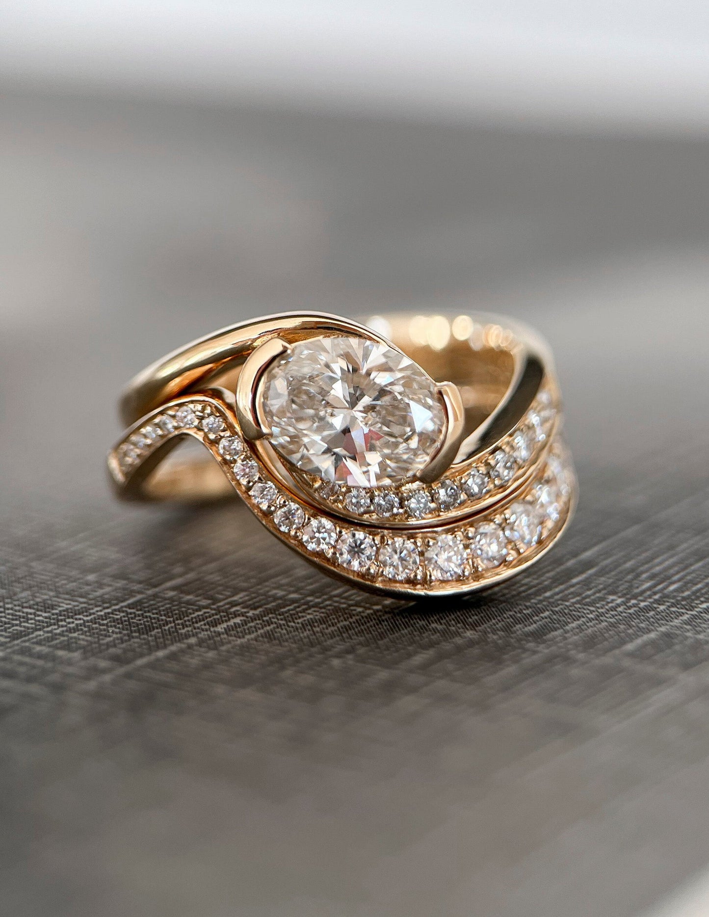 Solitaire Half Bezel Rapture & Pave Band- 1 CT Oval Lab Grown Diamond Bridal SetSolitaire Half Bezel Rapture & Pave Band- 1 CT Oval Lab Grown Diamond Bridal Set - Side view