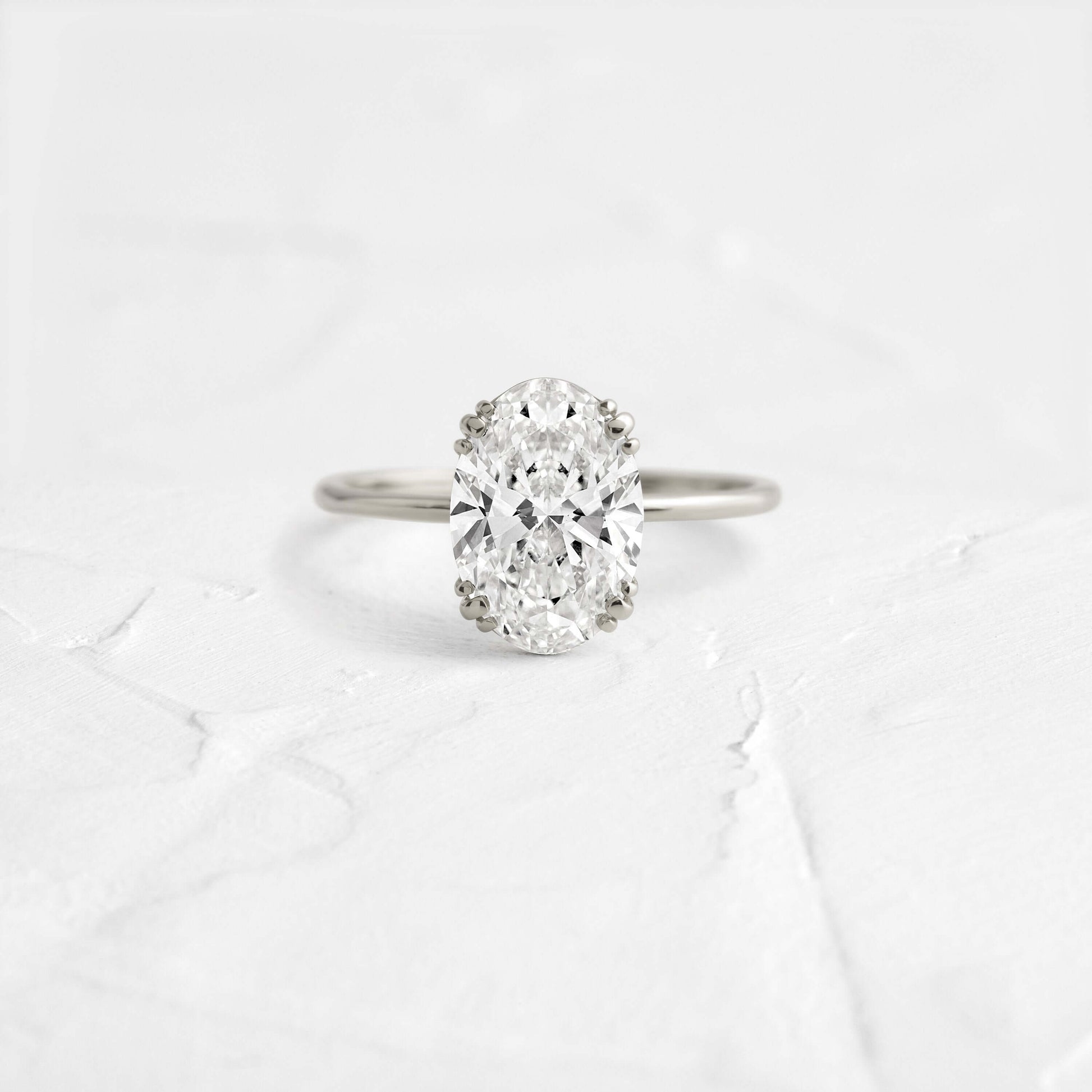 Solitaire Triple Prong with Hidden Stones-Oval Lab Grown Diamond Engagement Ring - Detail view