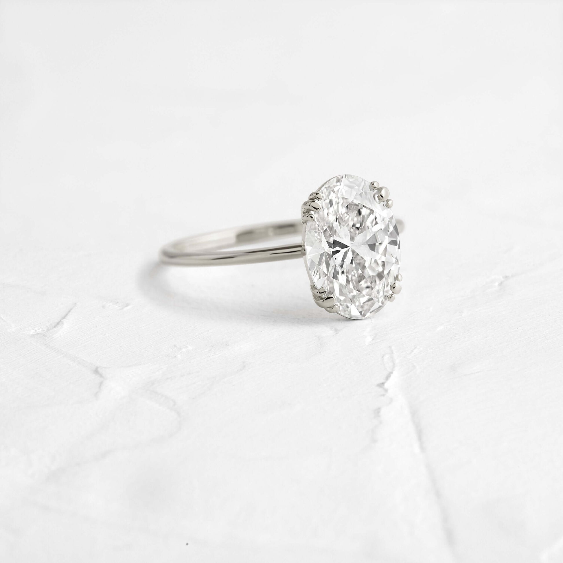 Solitaire Triple Prong with Hidden Stones-Oval Lab Grown Diamond Engagement Ring - On model