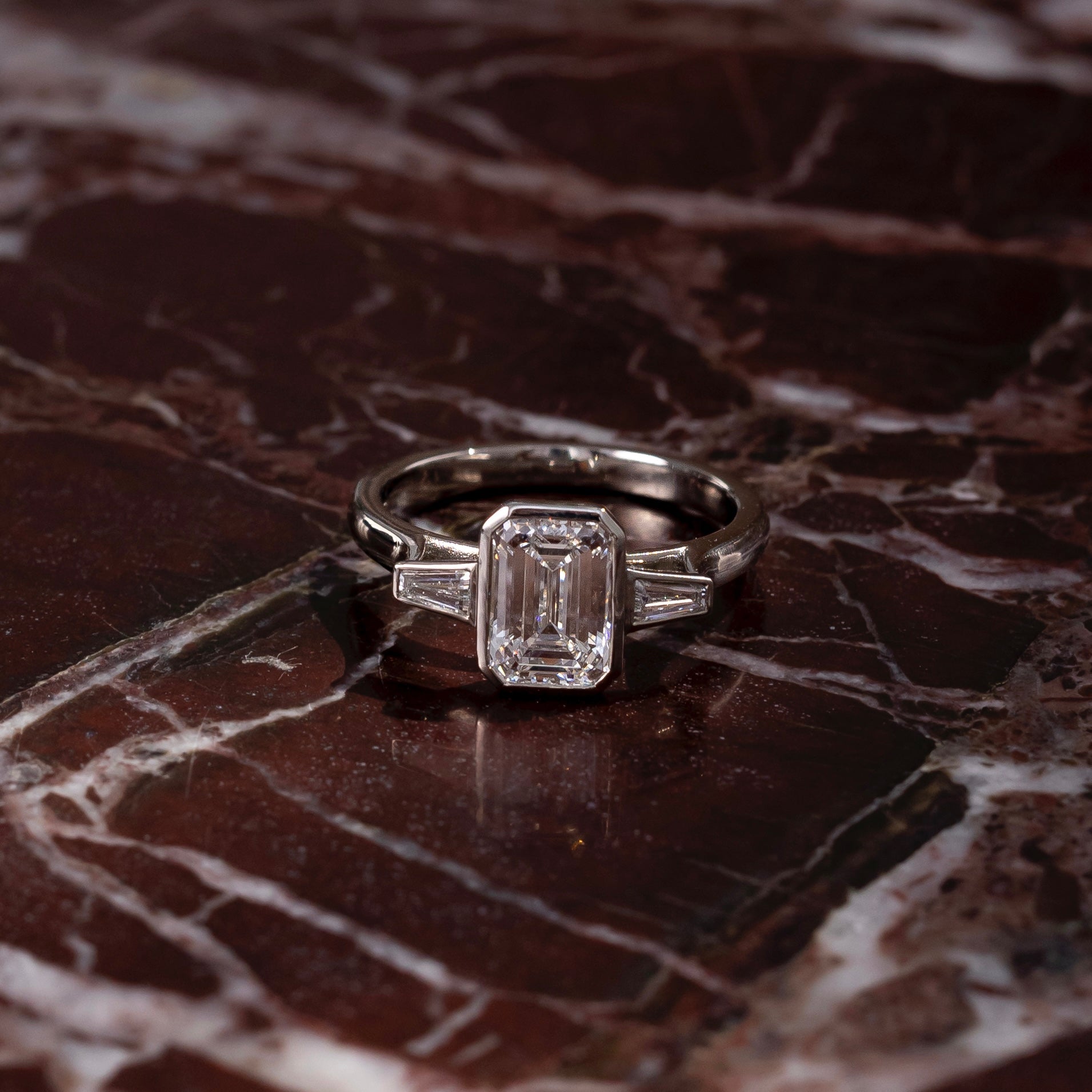 Three Stone Bezel Cathedral- 1.5 CT Emerald Moissanite Engagement RingThree Stone Bezel Cathedral- 1.5 CT Emerald Moissanite Engagement Ring - Side view