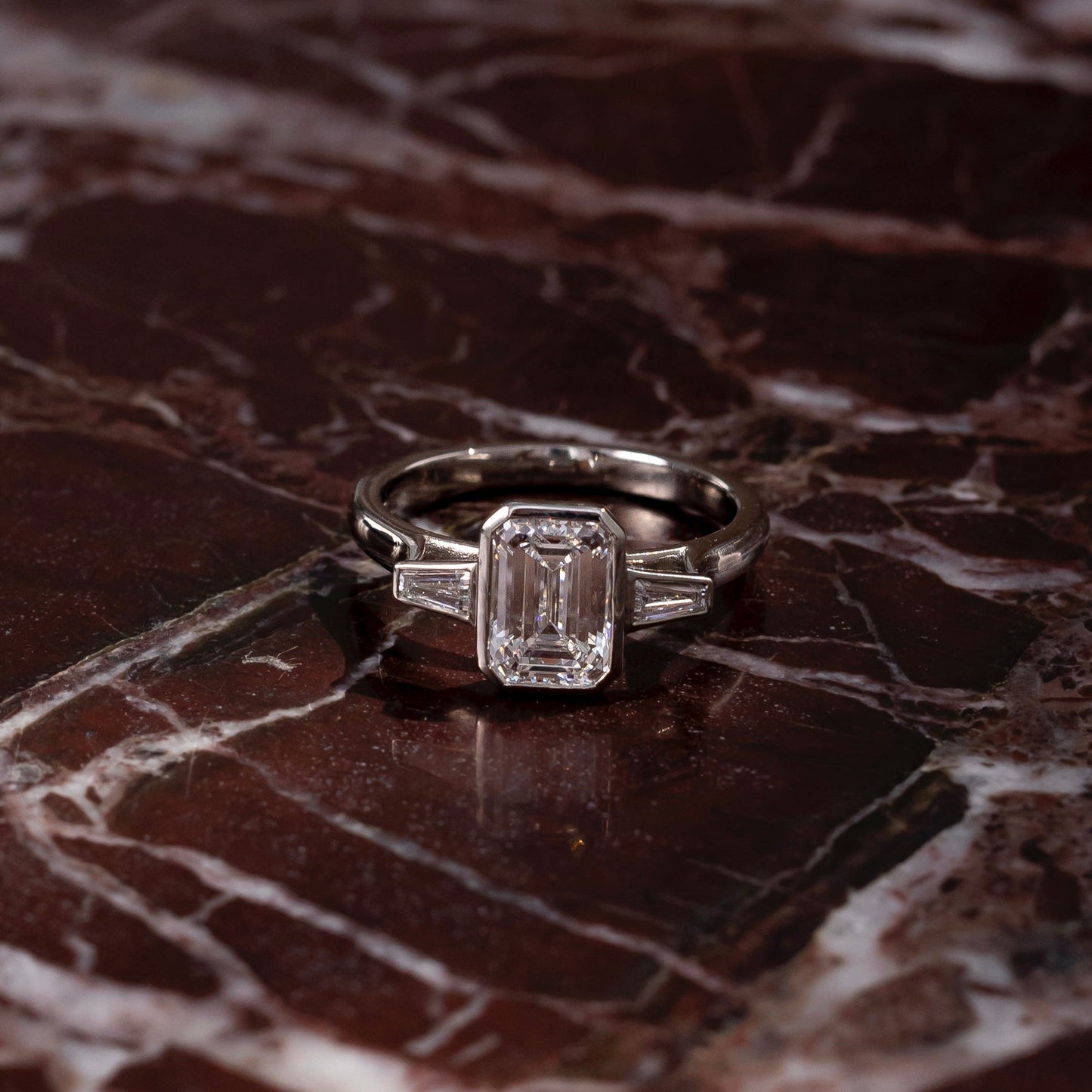 Three Stone Bezel Cathedral- 1.5 CT Emerald Moissanite Engagement RingThree Stone Bezel Cathedral- 1.5 CT Emerald Moissanite Engagement Ring - Side view