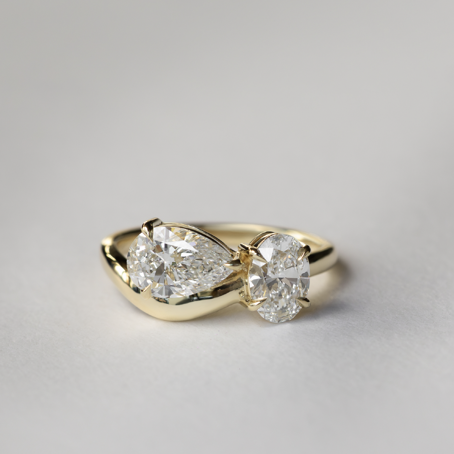 Toi Et Moi Curved- 1.25 CT Pear 0.95 CT Oval Moissanite Engagement RingToi Et Moi Curved- 1.25 CT Pear 0.95 CT Oval Moissanite Engagement Ring - Side view