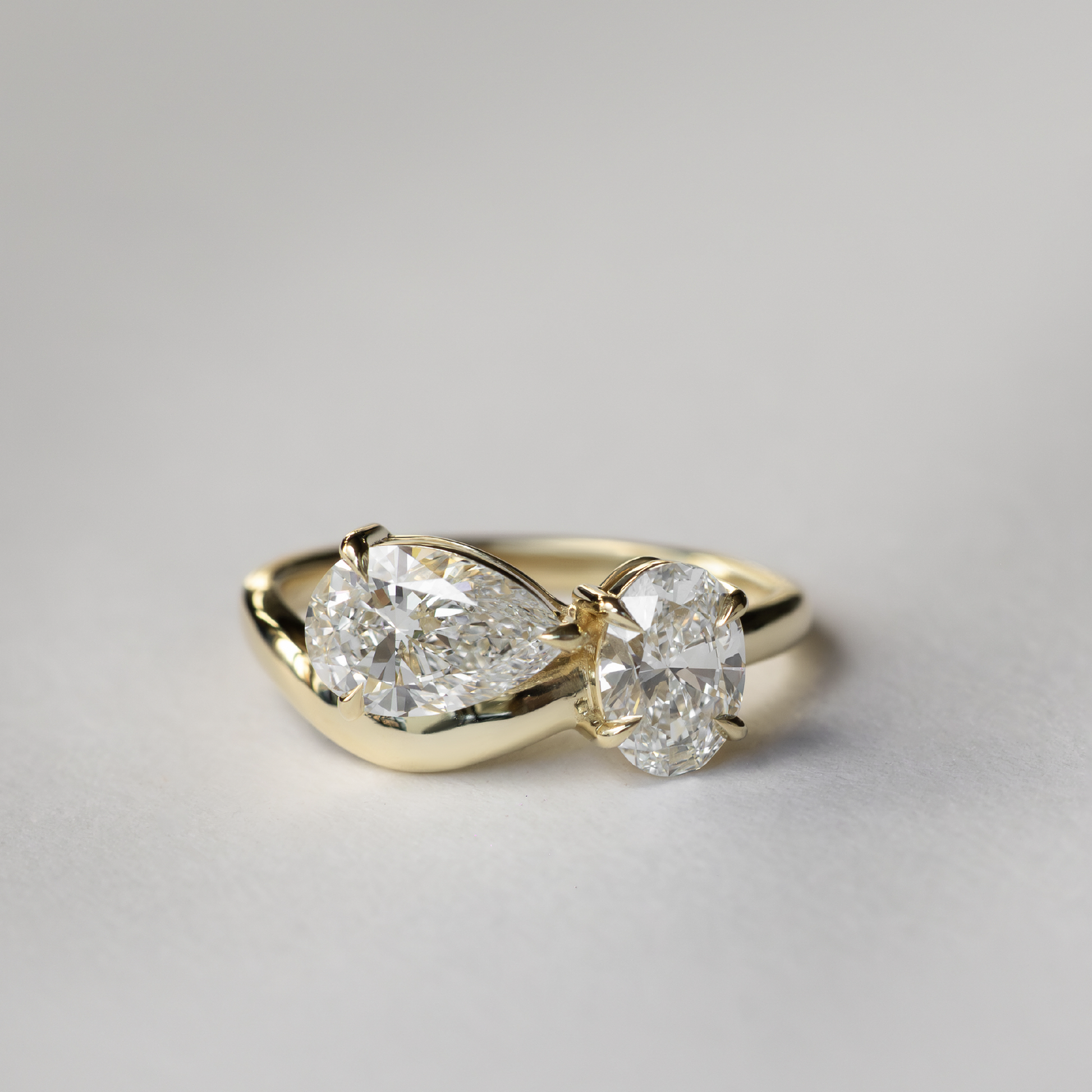 Toi Et Moi Curved- 1.25 CT Pear 0.95 CT Oval Moissanite Engagement RingToi Et Moi Curved- 1.25 CT Pear 0.95 CT Oval Moissanite Engagement Ring - Side view