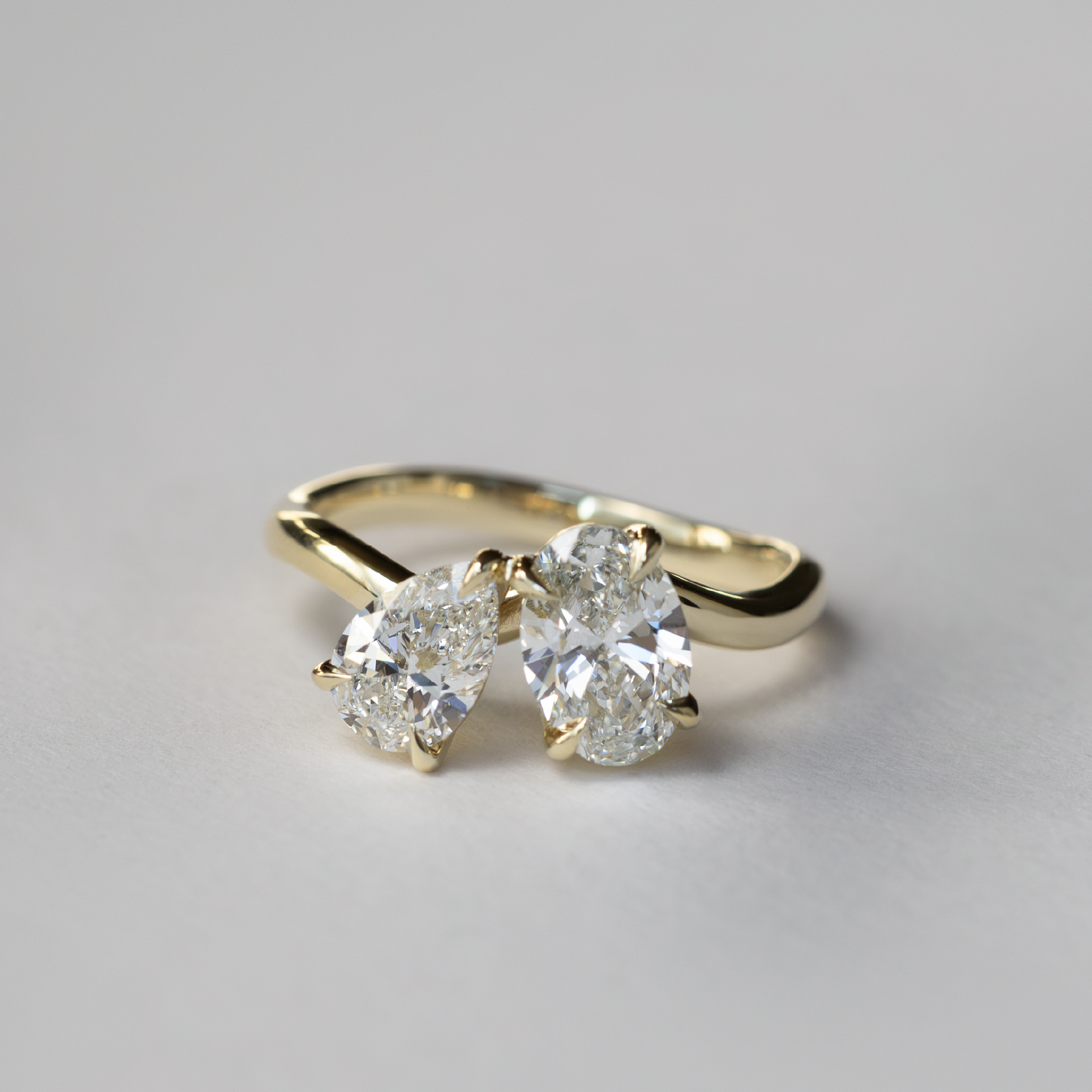 Toi Et Moi Curved- 1.3 CT Oval & 0.85 CT Pear Moissanite Engagement RingToi Et Moi Curved- 1.3 CT Oval & 0.85 CT Pear Moissanite Engagement Ring - Side view