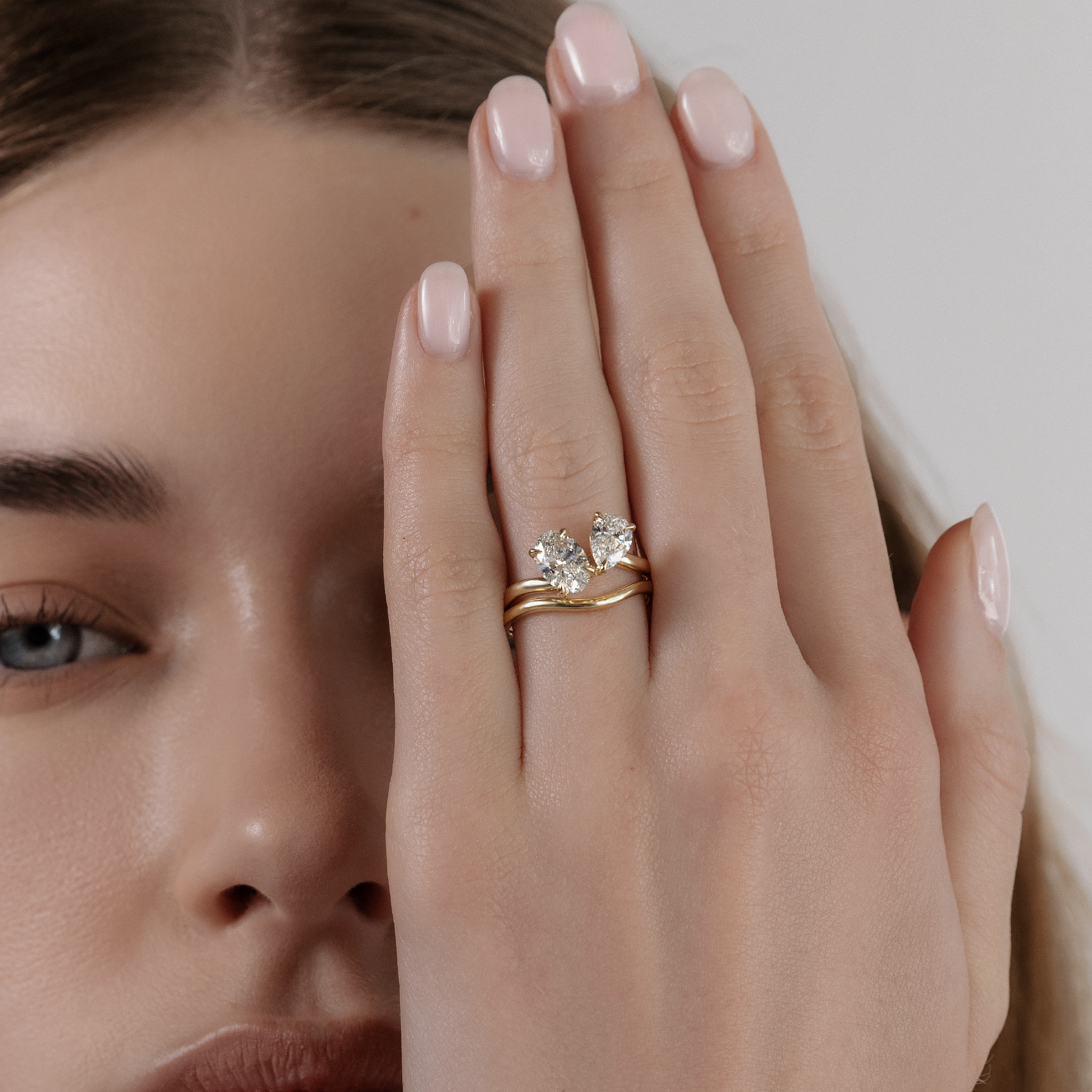 Toi Et Moi Curved- 1.3 CT Oval & 0.85 CT Pear Moissanite Engagement RingToi Et Moi Curved- 1.3 CT Oval & 0.85 CT Pear Moissanite Engagement Ring - Lifestyle